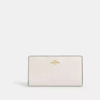 Cartera fina con cremallera de Coach en lona distintiva 