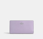 Cartera fina con cremallera de Coach en lona distintiva 