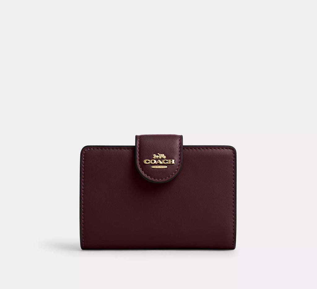 Cartera mediana con cremallera en las esquinas de Coach 